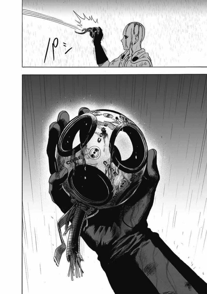 Saitama catches Genos' broken core, which Garou throws at him.